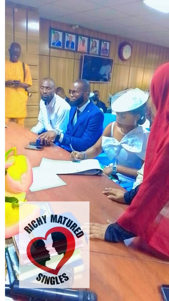 At the registry — a couple married through Richy Mature Singles